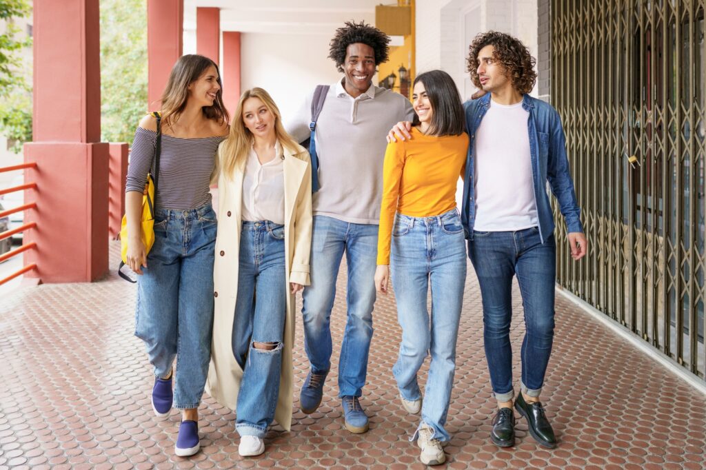 Multi-ethnic group of students walking together on the street.